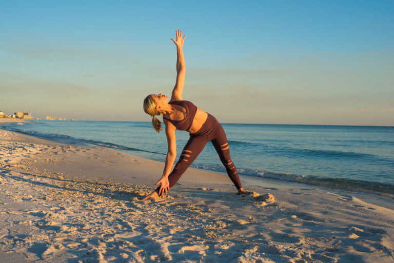 woman in yoga attire on beach doing extended triangle pose, extended triangle pose, beach, yoga photography, yoga photographer, atlanta yoga photographer, atlanta photographer,