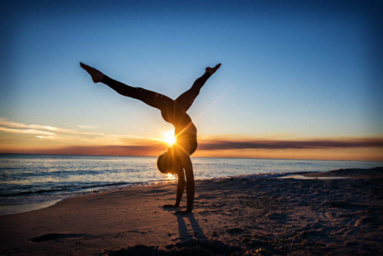 woman dressed in yoga attire doing yoga on a beach at sunset, beach, yoga photography, yoga photographer, atlanta yoga photographer, atlanta photographer, 